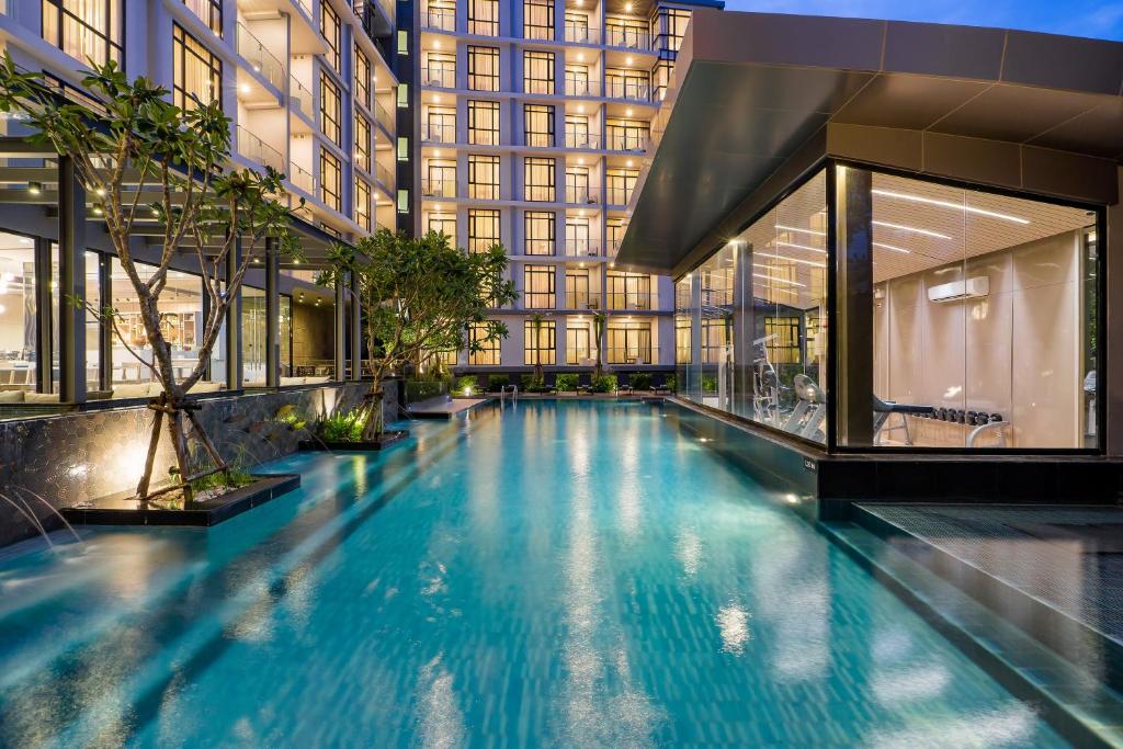 a swimming pool in the middle of a building at Arden Hotel and Residence by At Mind in Pattaya Central