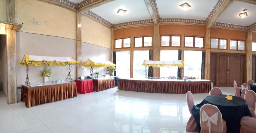 a large room with tables and chairs in it at Hotel Nadia Bromo in Bromo