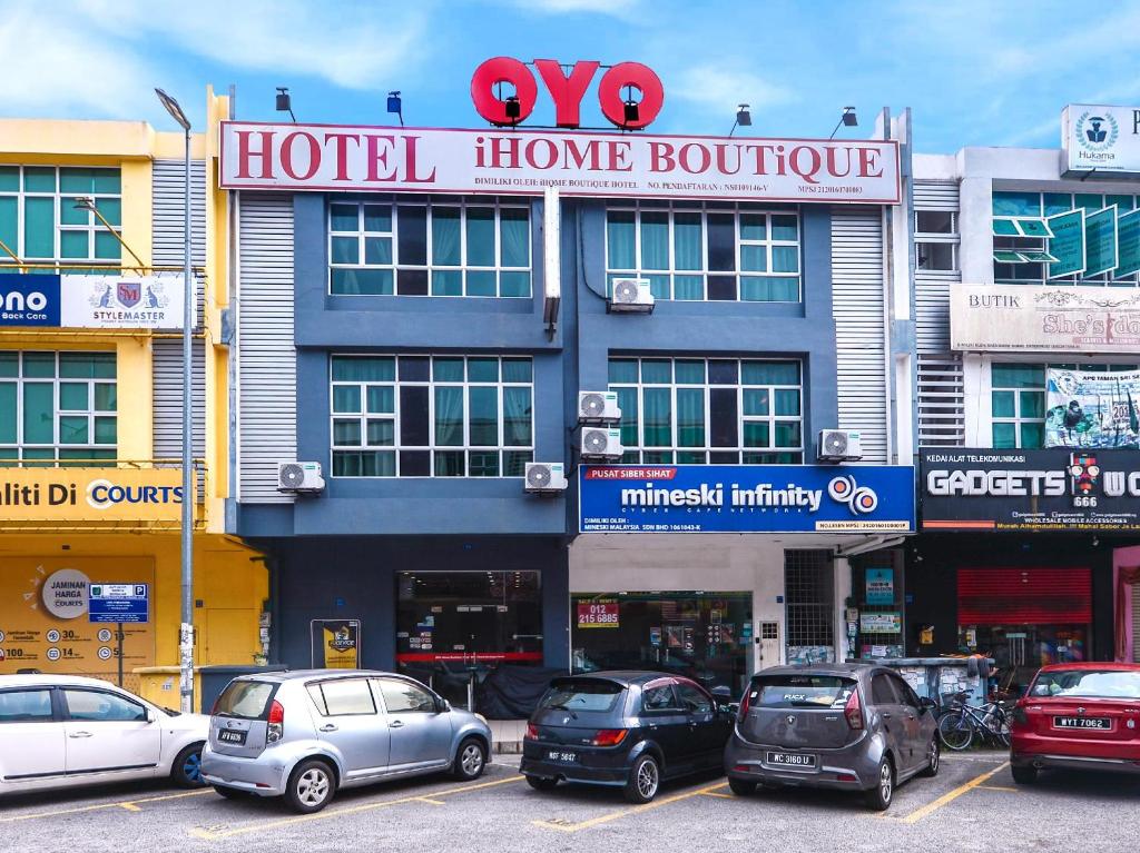 a hotel home boutique with cars parked in a parking lot at Ihome Boutique Hotel in Seri Kembangan