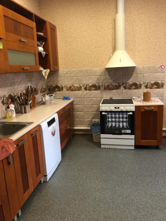 a kitchen with a sink and a stove top oven at Hotel - Hostel Marichka in Khmilnyk