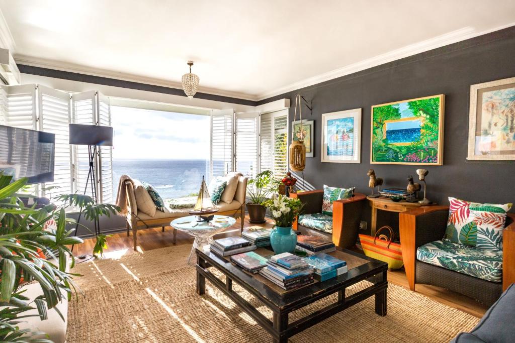 a living room with a view of the ocean at Watercolours Studios in Simonʼs Town