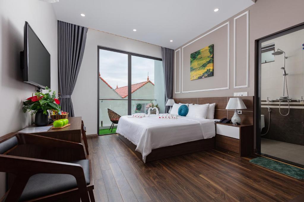 a hotel room with a bed and a window at Airport Classic Hotel & Travel in Hanoi