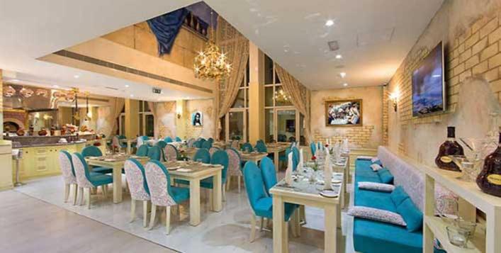 
a dining room with tables and chairs in it at Al Khaleej Palace Deira Hotel in Dubai
