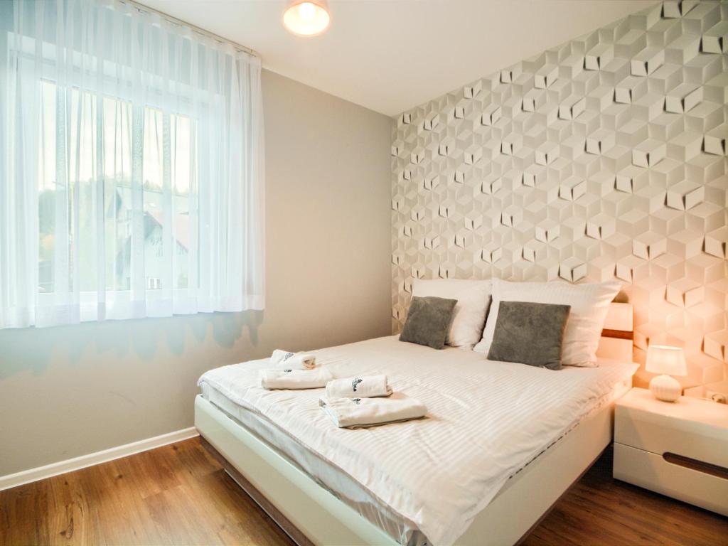 Postel nebo postele na pokoji v ubytování Apartamenty Szarotka