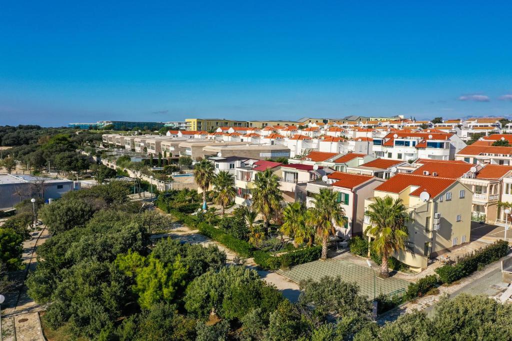 an aerial view of a city with houses and trees at Apartments Malic in Petrcane