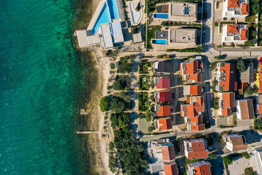 an aerial view of a village next to the ocean at Apartments Malic in Petrcane