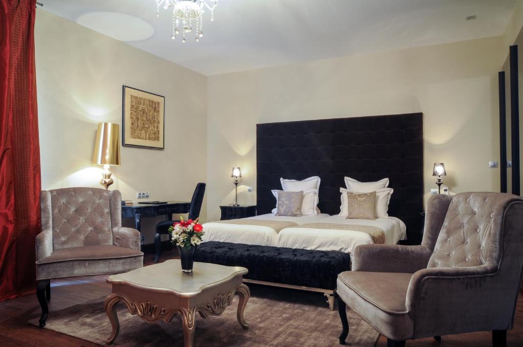 Postel nebo postele na pokoji v ubytování Hôtel Demeure Loredana