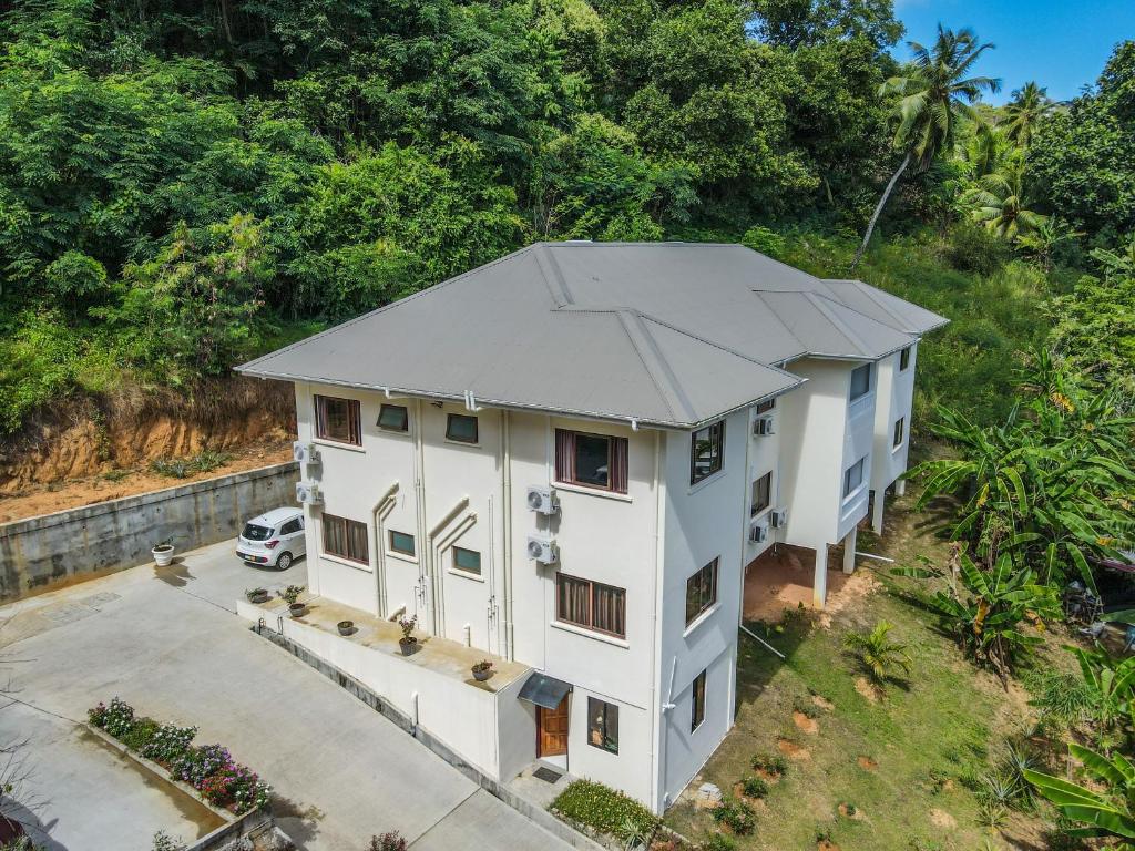 an overhead view of a white house with a parking lot at Kanasuk Self catering Apartments in Baie Lazare Mahé