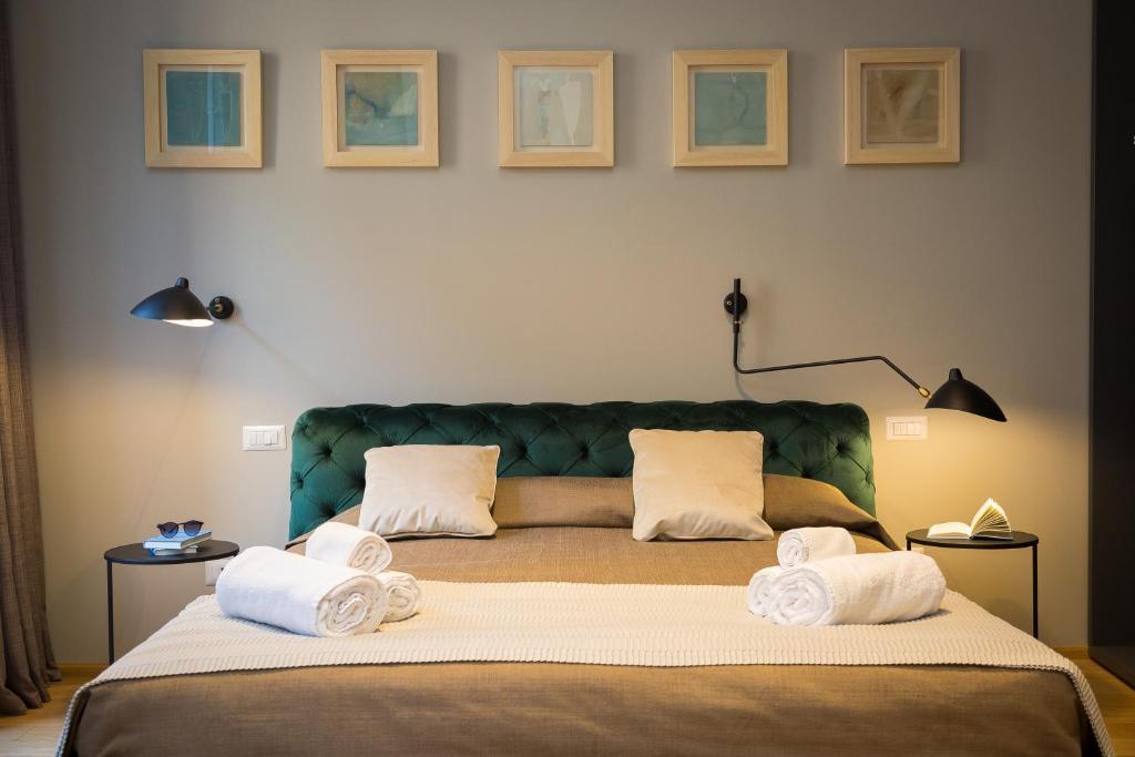 a bedroom with a large bed with towels on it at Suite della Pigna in Rome