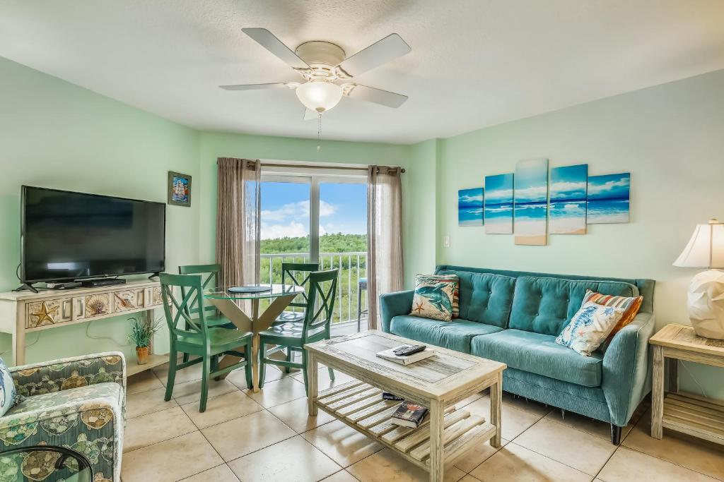 a living room with a couch and a table at Aqua Vista in Tavernier