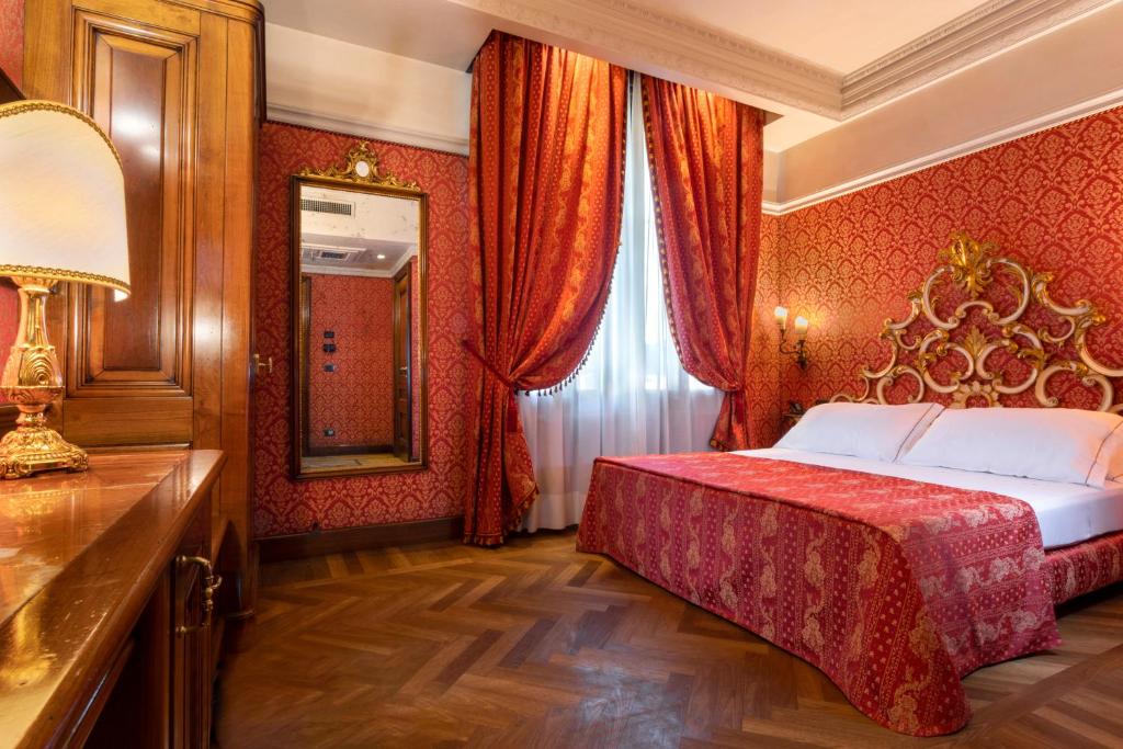 Łóżko lub łóżka w pokoju w obiekcie Palazzina Veneziana