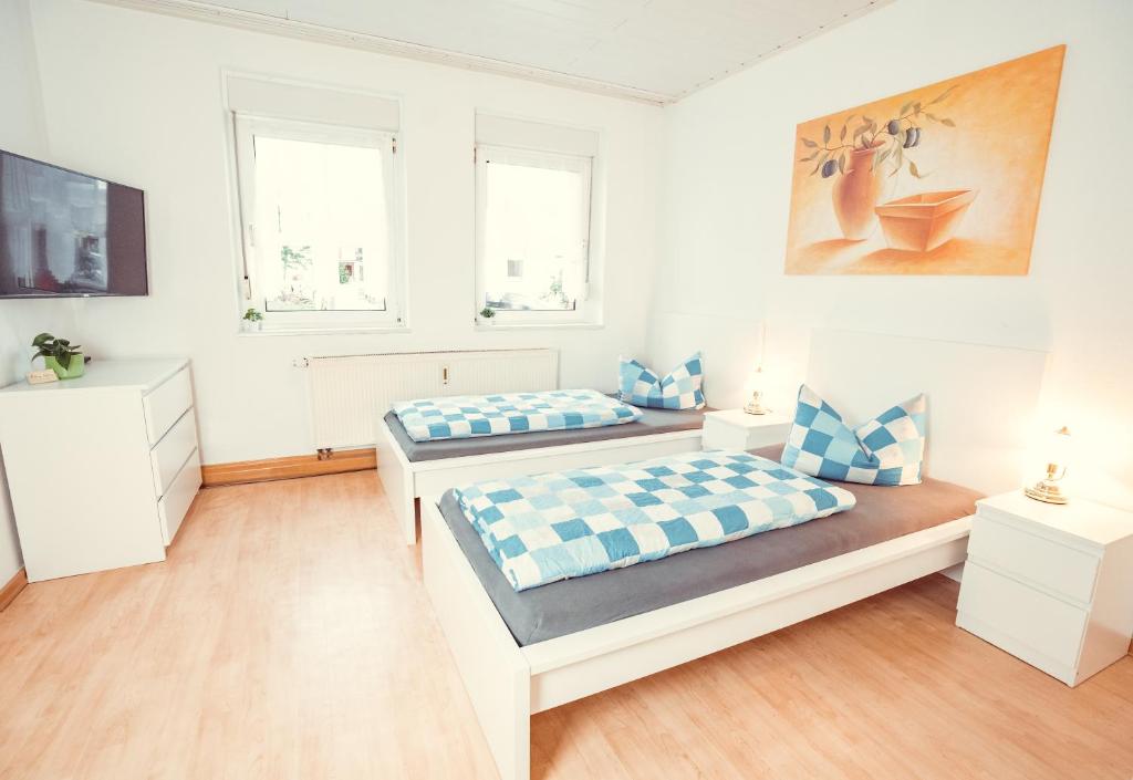 Postel nebo postele na pokoji v ubytování Auberge Leipzig