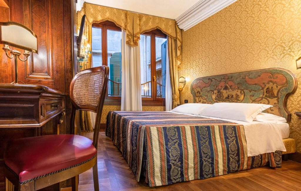 Łóżko lub łóżka w pokoju w obiekcie Palazzina Veneziana