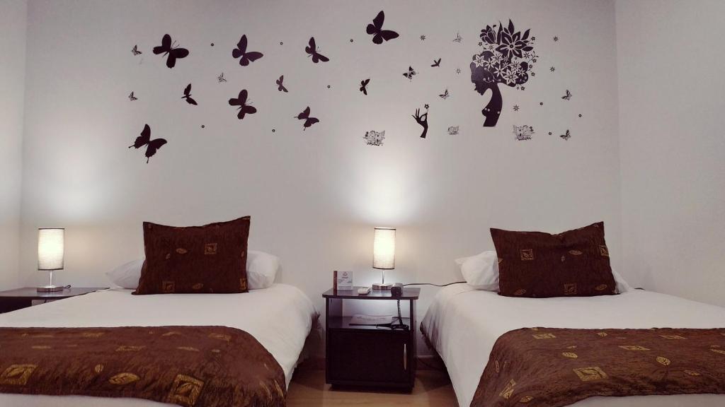 Postel nebo postele na pokoji v ubytování Hotel Confort Bogota