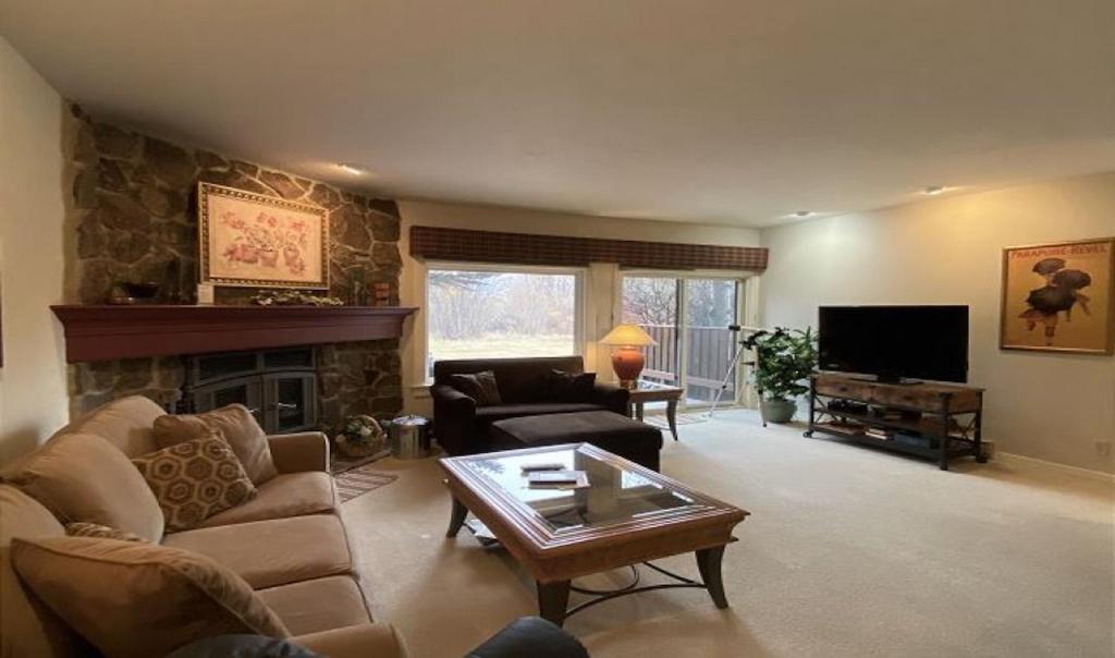 a living room with a couch and a fireplace at Moran B in Jackson