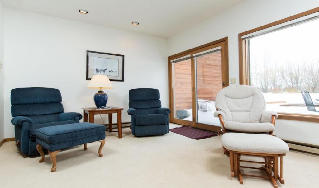 a living room with two chairs and a window at St John C in Jackson