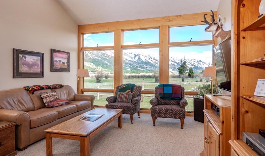 a living room with a couch and chairs and a large window at 4412 Mackinaw in Wilson