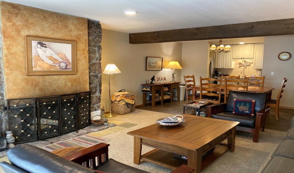 a living room with a fireplace and a dining room at White Ridge B2 in Teton Village