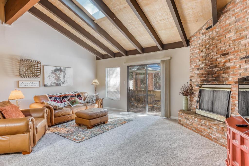 a living room with a fireplace and a brick wall at Mountain Shadows in Incline Village