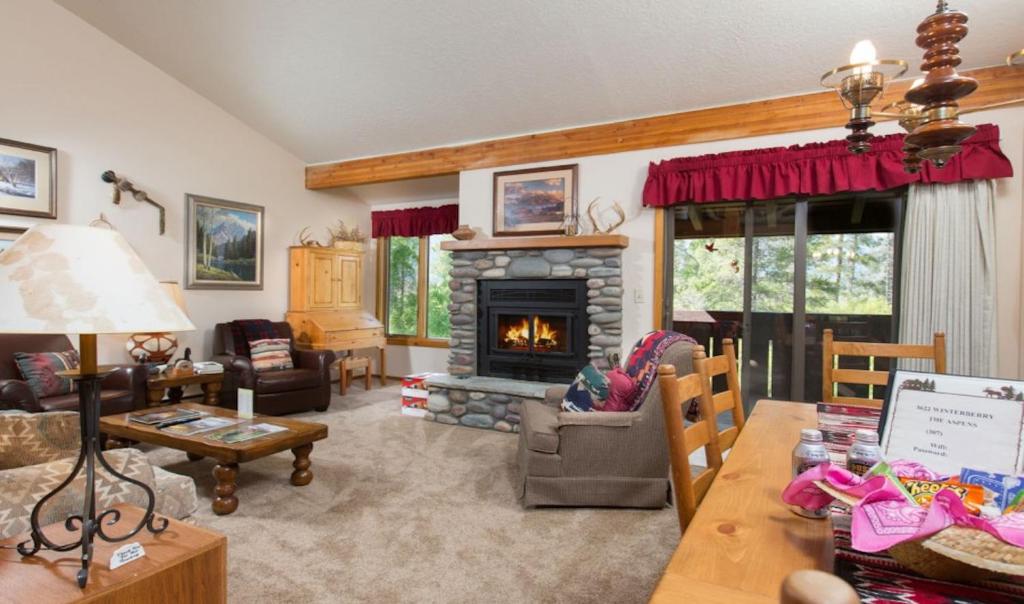 a living room with a fireplace and a table at 3622 Winterberry in Wilson
