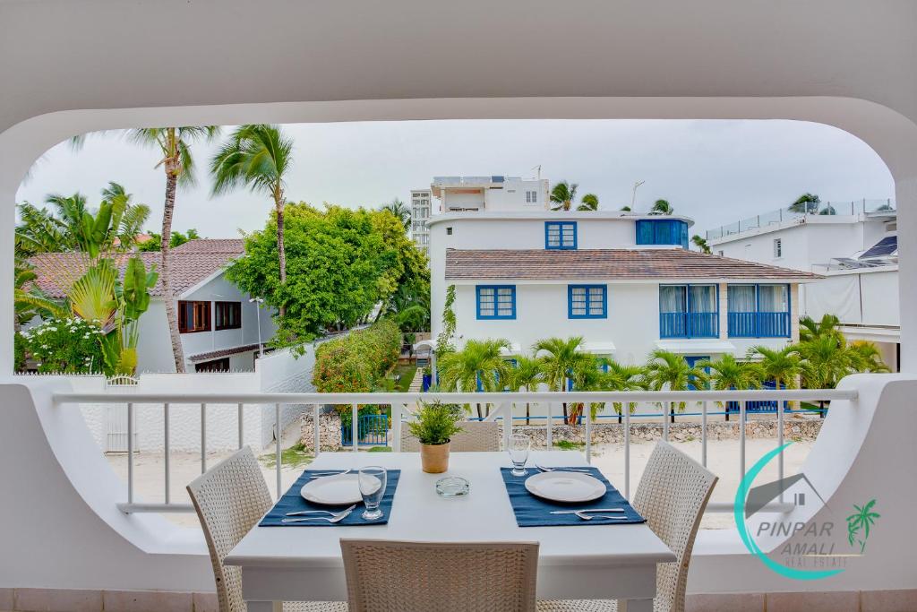 a table on a balcony with a view of a building at Ocean View! beautiful Flor Del Mar, 2BR, 2BT in Punta Cana