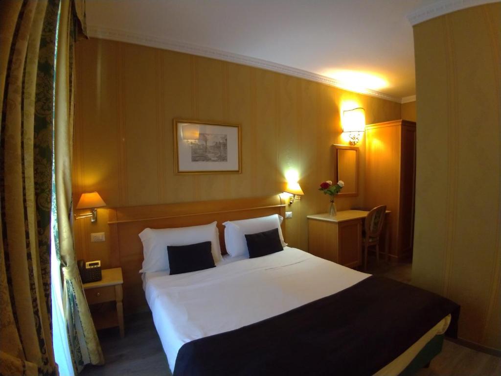 Postel nebo postele na pokoji v ubytování Hotel dei Quiriti
