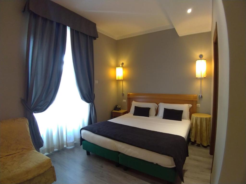Postel nebo postele na pokoji v ubytování Hotel dei Quiriti