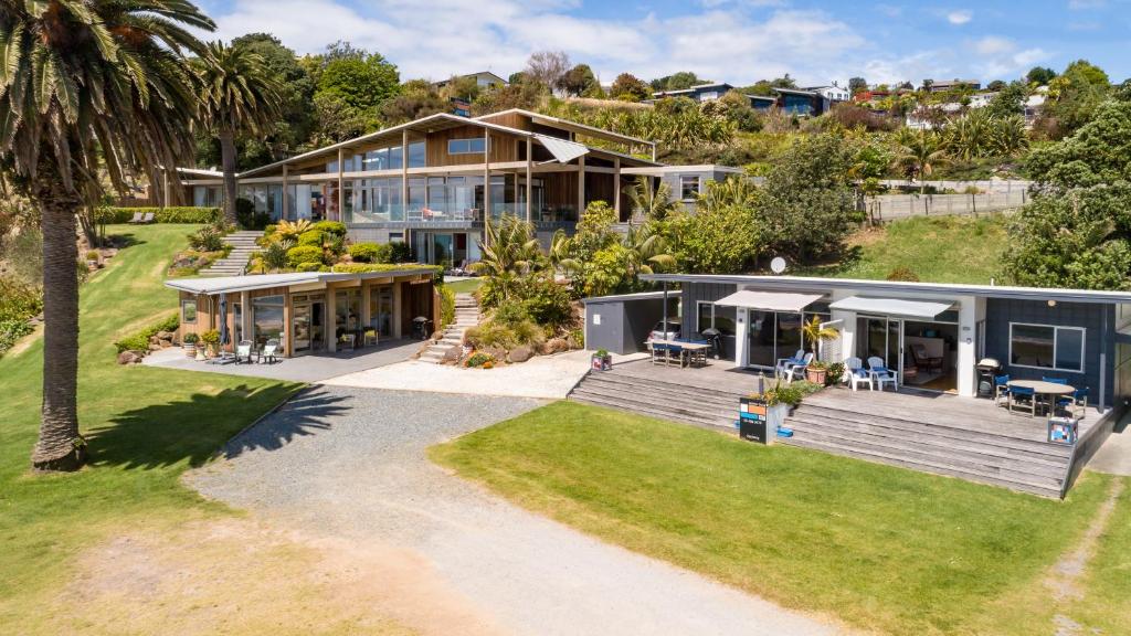 an aerial view of a house with a yard at Golden Sand Beachfront Accommodation in Coopers Beach