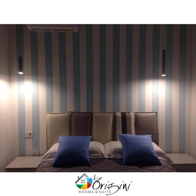 Postel nebo postele na pokoji v ubytování Le Origini Rooms&Suite