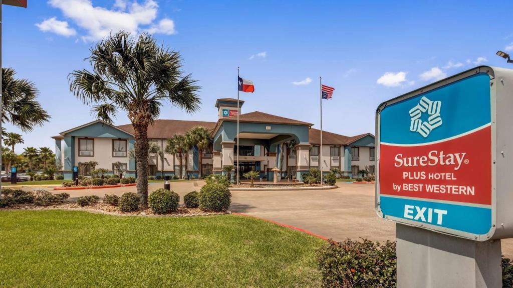 a sign in front of a building with a streetley puts your best western at SureStay Plus Hotel by Best Western Alvin in Alvin