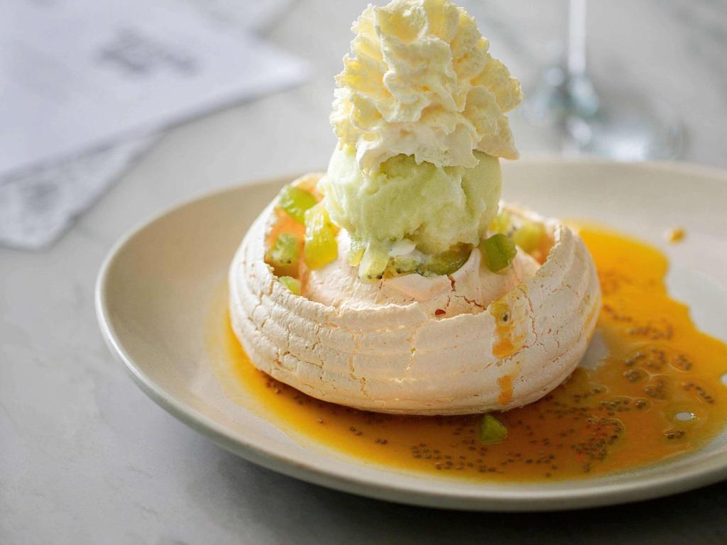 a dessert on a plate with ice cream on it at Novotel Auckland Airport in Auckland