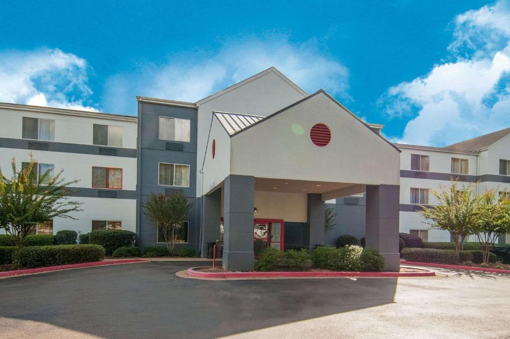 a large white building with a parking lot at Quality Inn & Suites in Jackson