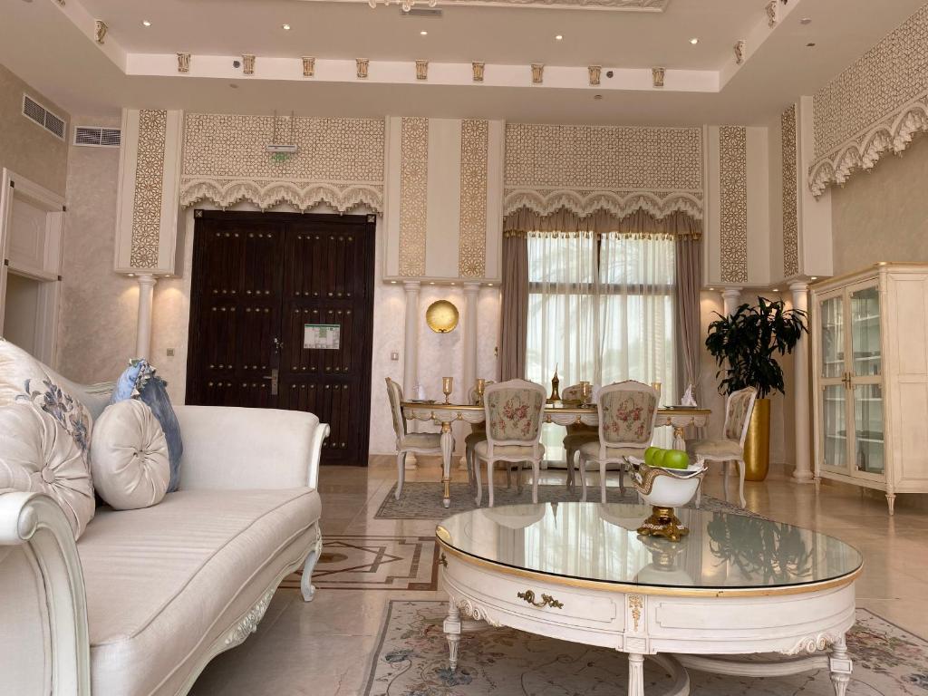 a living room with a couch and a table at Western Hotel - Madinat Zayed in Madīnat Zāyid