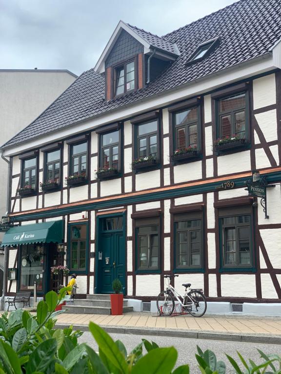 a building with two bikes parked in front of it at Pension Karina Schwerin in Schwerin