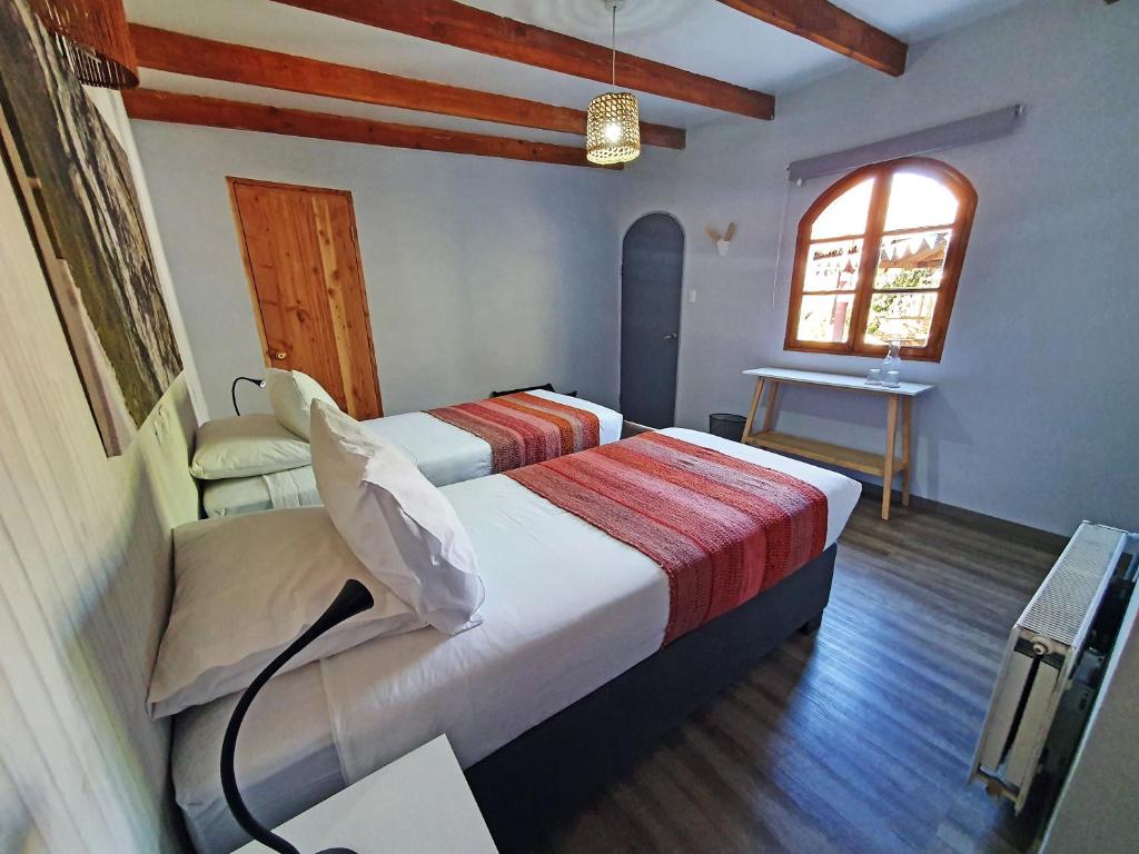 Postel nebo postele na pokoji v ubytování Hotel Jardin Atacama