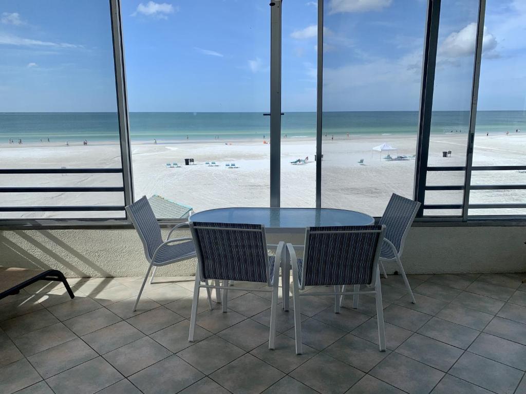 a table and chairs with a view of a beach at Island House Beach Resort 5S in Siesta Key