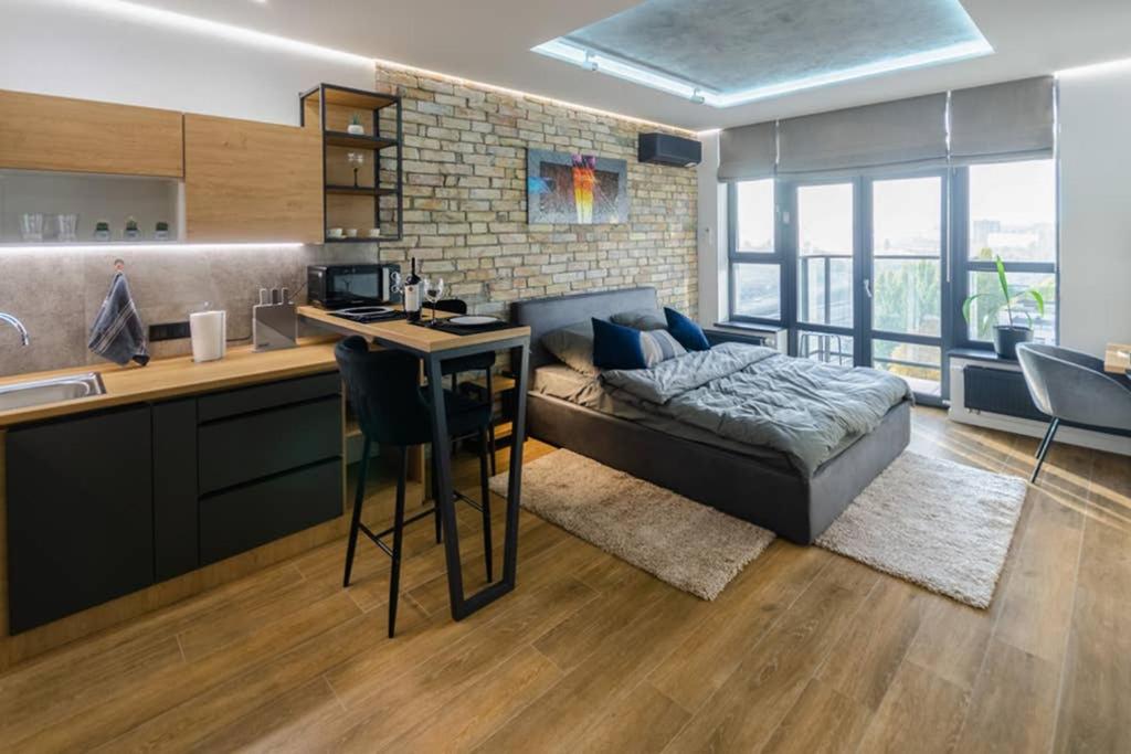 a kitchen and living room with a couch and a table at VIP - Smart in Kyiv