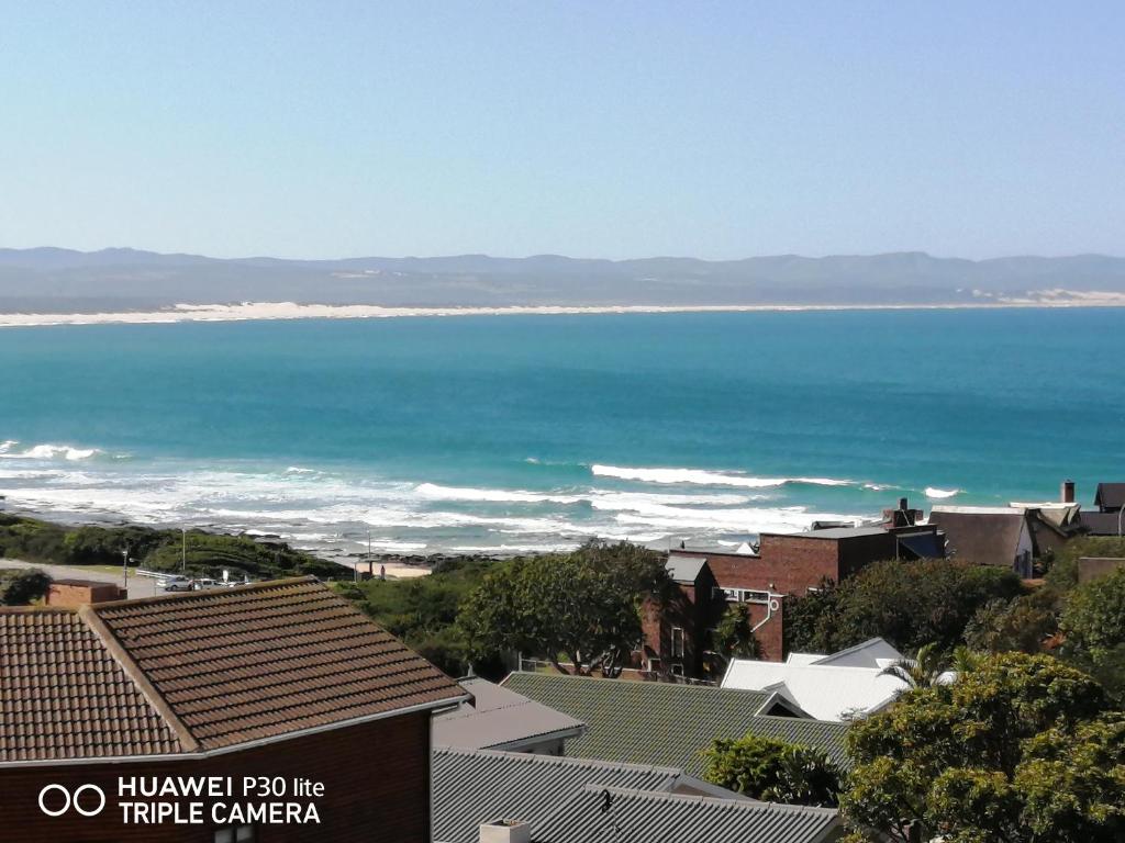 a view of the ocean from a town with houses at Beautiful Sea View Room in Jeffreys Bay