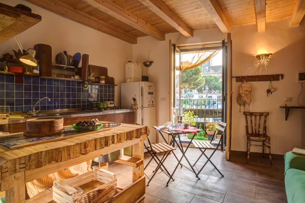 a kitchen with a counter and a table in a room at Casa Verde in Catania