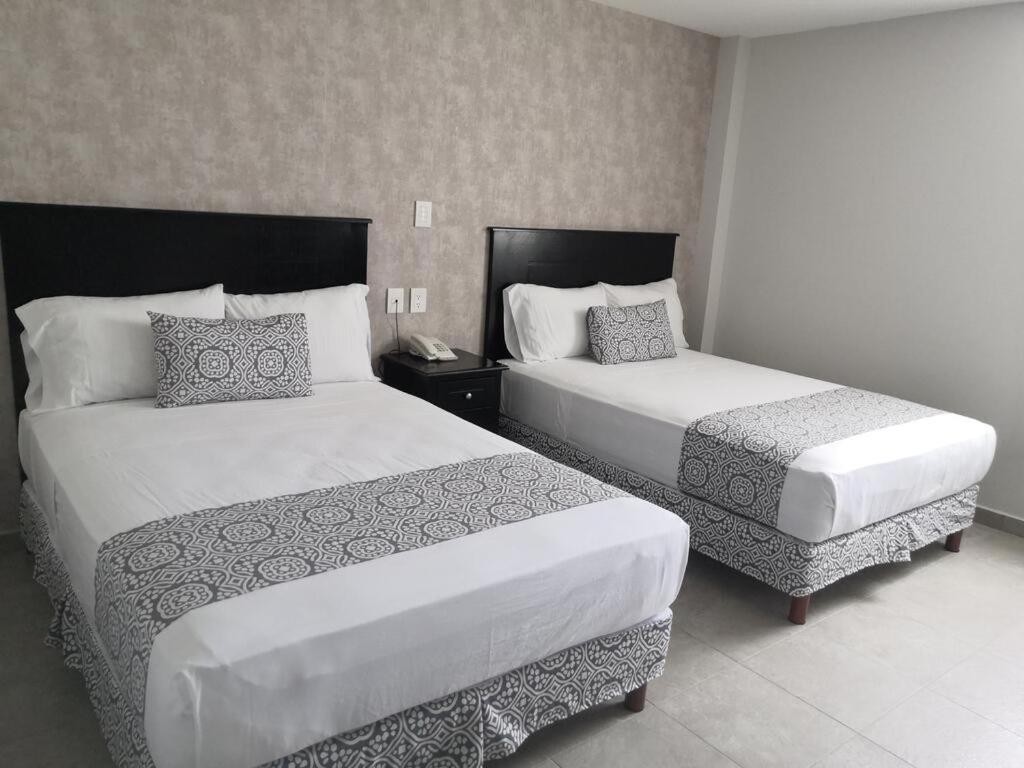 Postel nebo postele na pokoji v ubytování Hotel Costa Verde