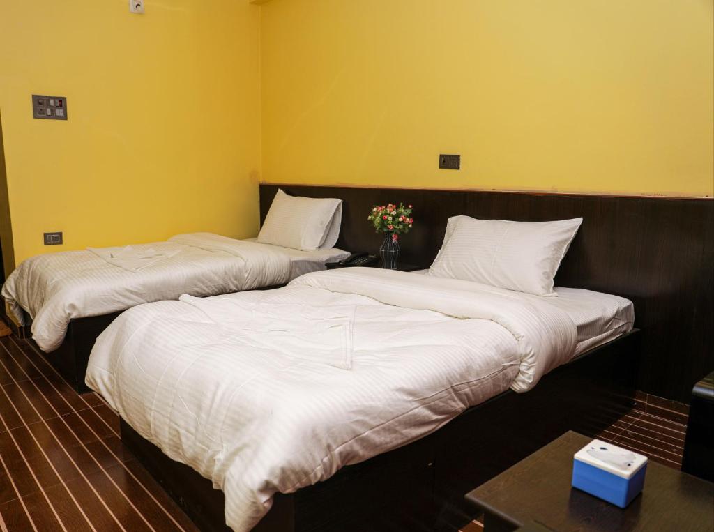 Postel nebo postele na pokoji v ubytování New sunlight Hotel