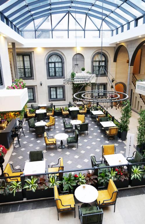 an empty patio with tables and chairs in a building at Amida Boutique Otel in Diyarbakır