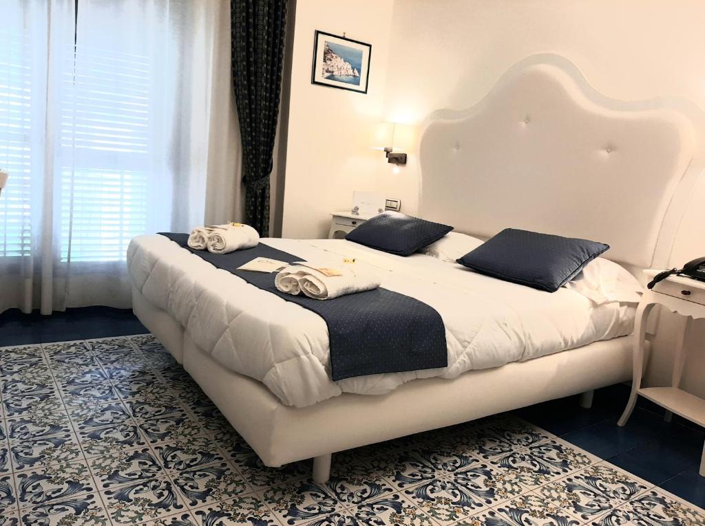 a bedroom with a large bed with towels on it at Hotel Santa Lucia in Minori