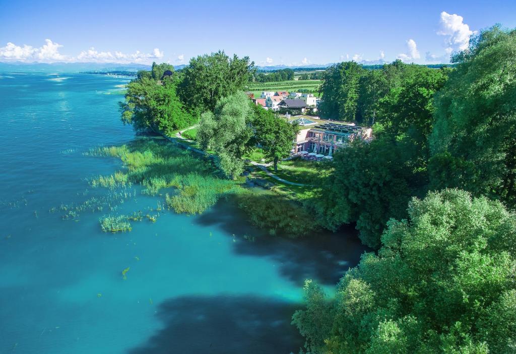 eine Luftansicht auf einen Fluss mit Bäumen und einem Haus in der Unterkunft Hotel Restaurant Sokrates in Güttingen