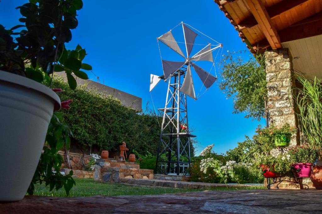 a windmill in the yard of a house at Anixiatiko Villa in Stalida