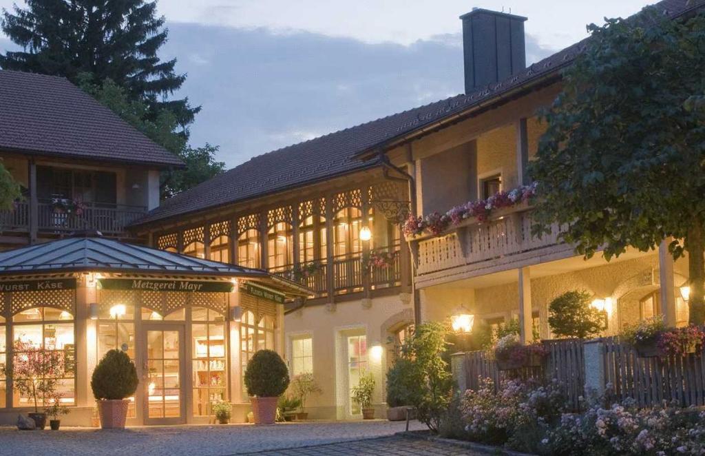 a large building with a lot of windows and lights at Gasthof Mayrwirt in Saaldorf