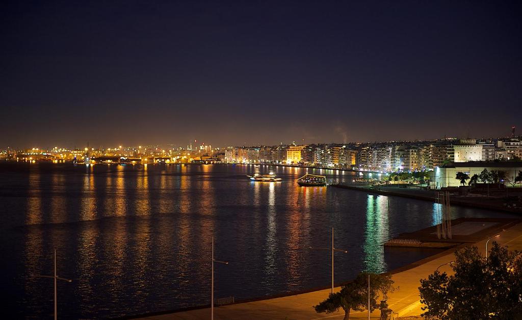 a view of a river at night with a city at Abc Hotel in Thessaloniki