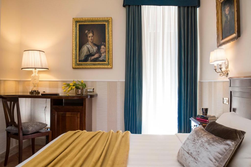 Postel nebo postele na pokoji v ubytování Hotel Des Artistes Roma