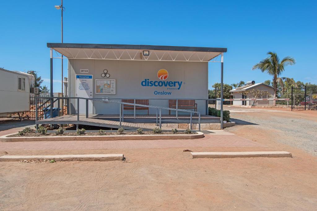 a gas station with a sign on the side of it at Discovery Parks - Onslow in Onslow