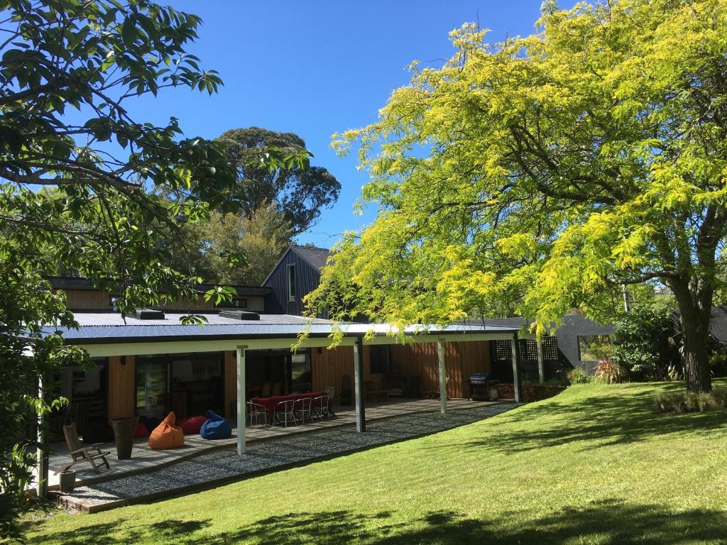 a house with a large yard in front of it at Korepo Lodge @ Ruby Bay in Nelson